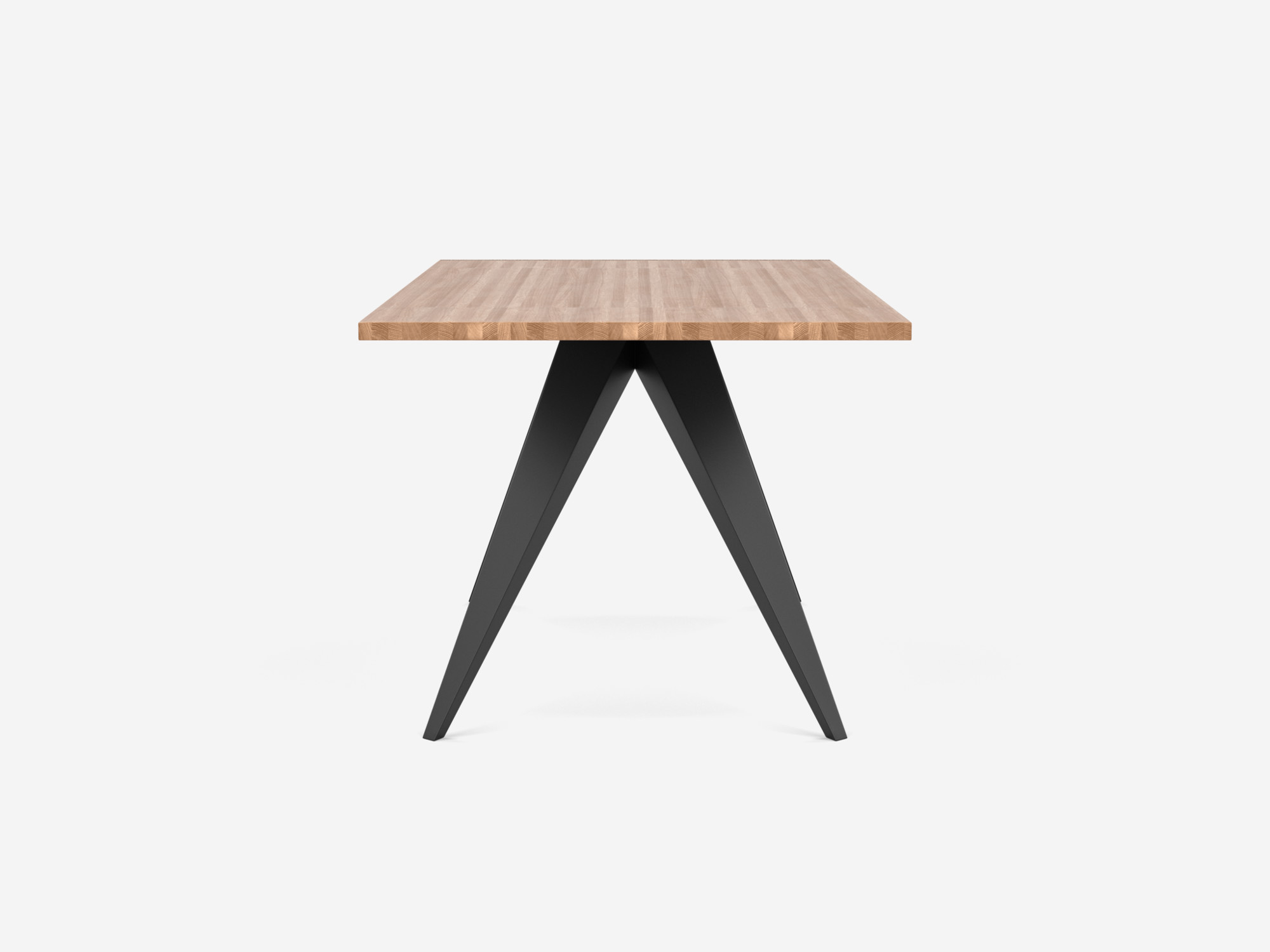 Side view of the Mesa unique dining table design with oak top and black base