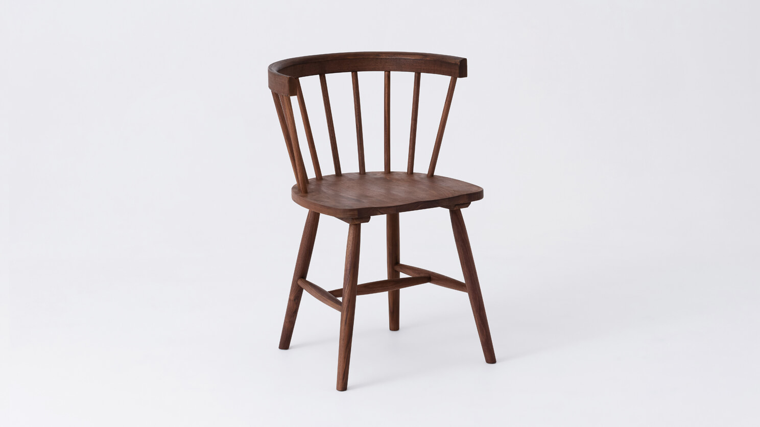 Angled view of the Lyla dining room chair in solid walnut