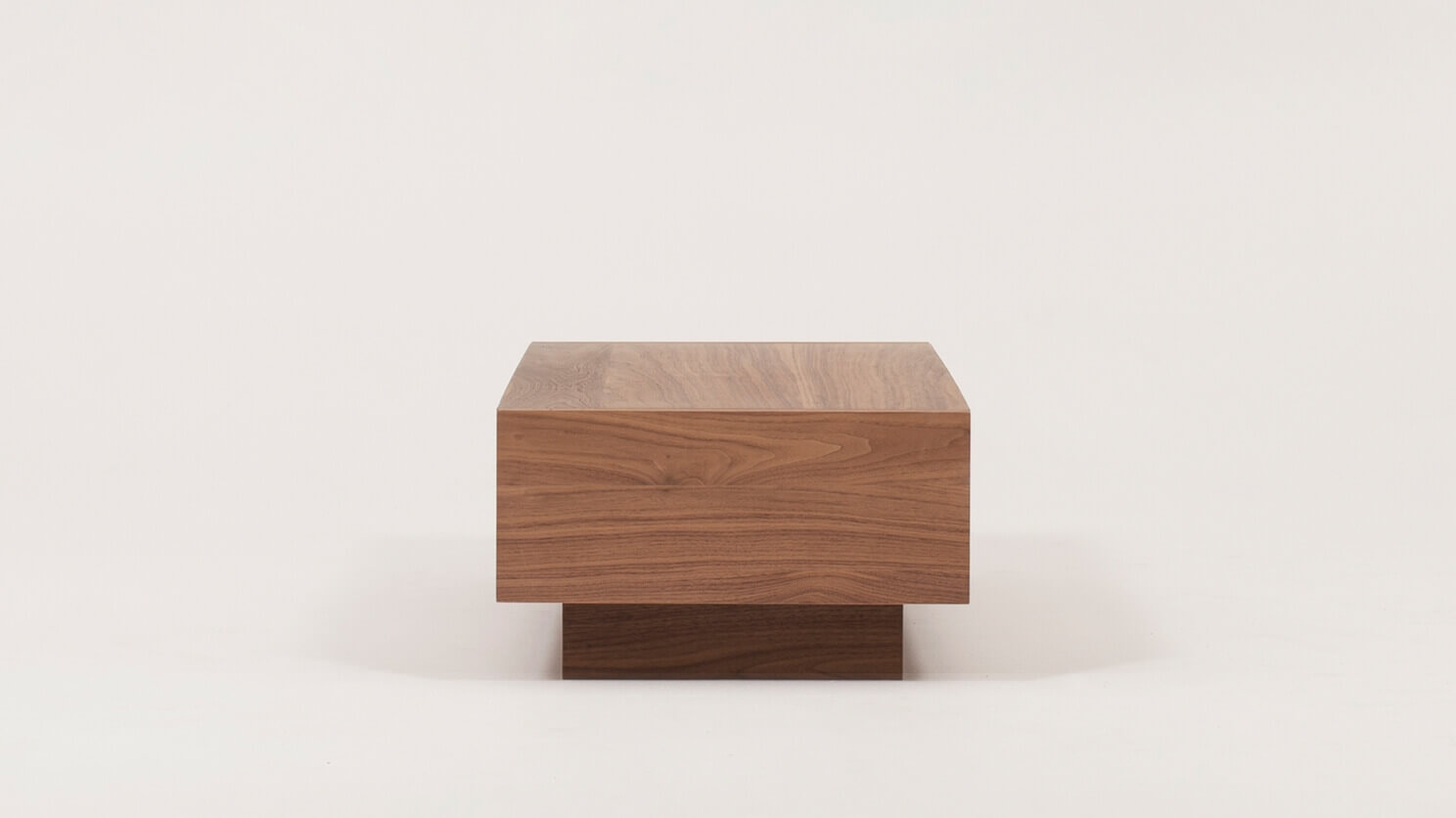 Side view of the Boom 2-drawer modern coffee table for sectional in walnut