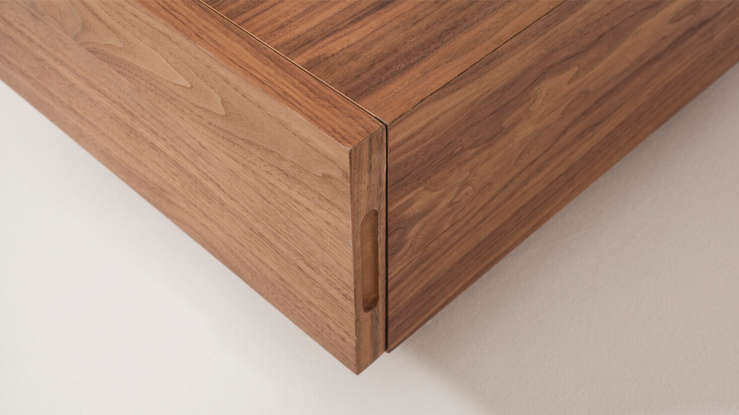 Corner detail view of the Boom 2-drawer modern coffee table for sectional in walnut