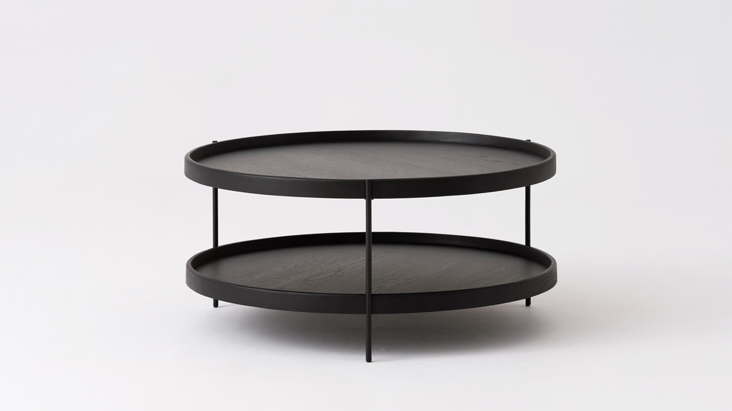 Front view of the small Sage round coffee table in black oak