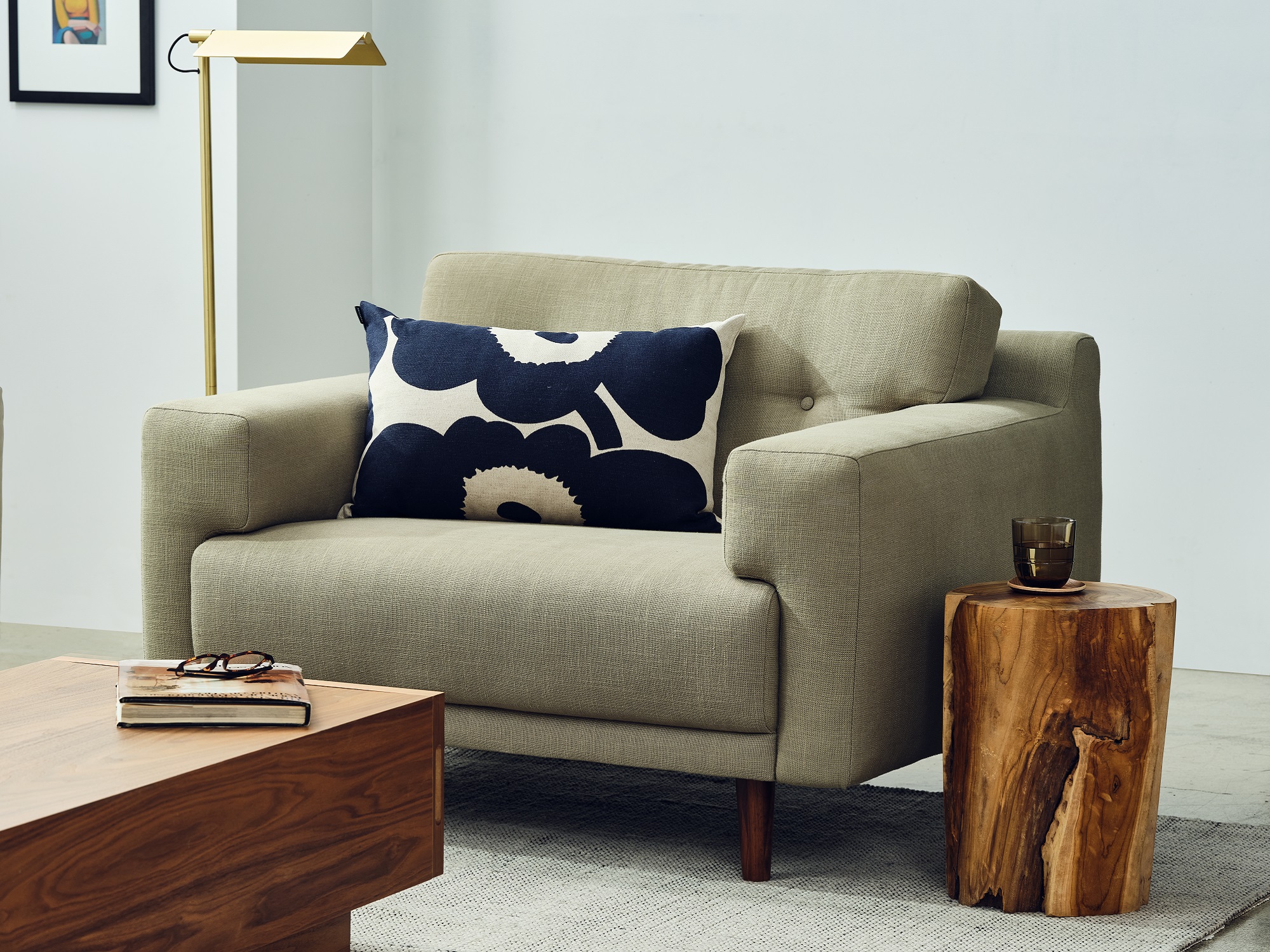 Grey mid century modern armchair with marimekko accent pillow and walnut coffee table