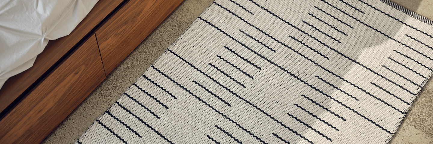 White and black pattern runner rug on beige floor