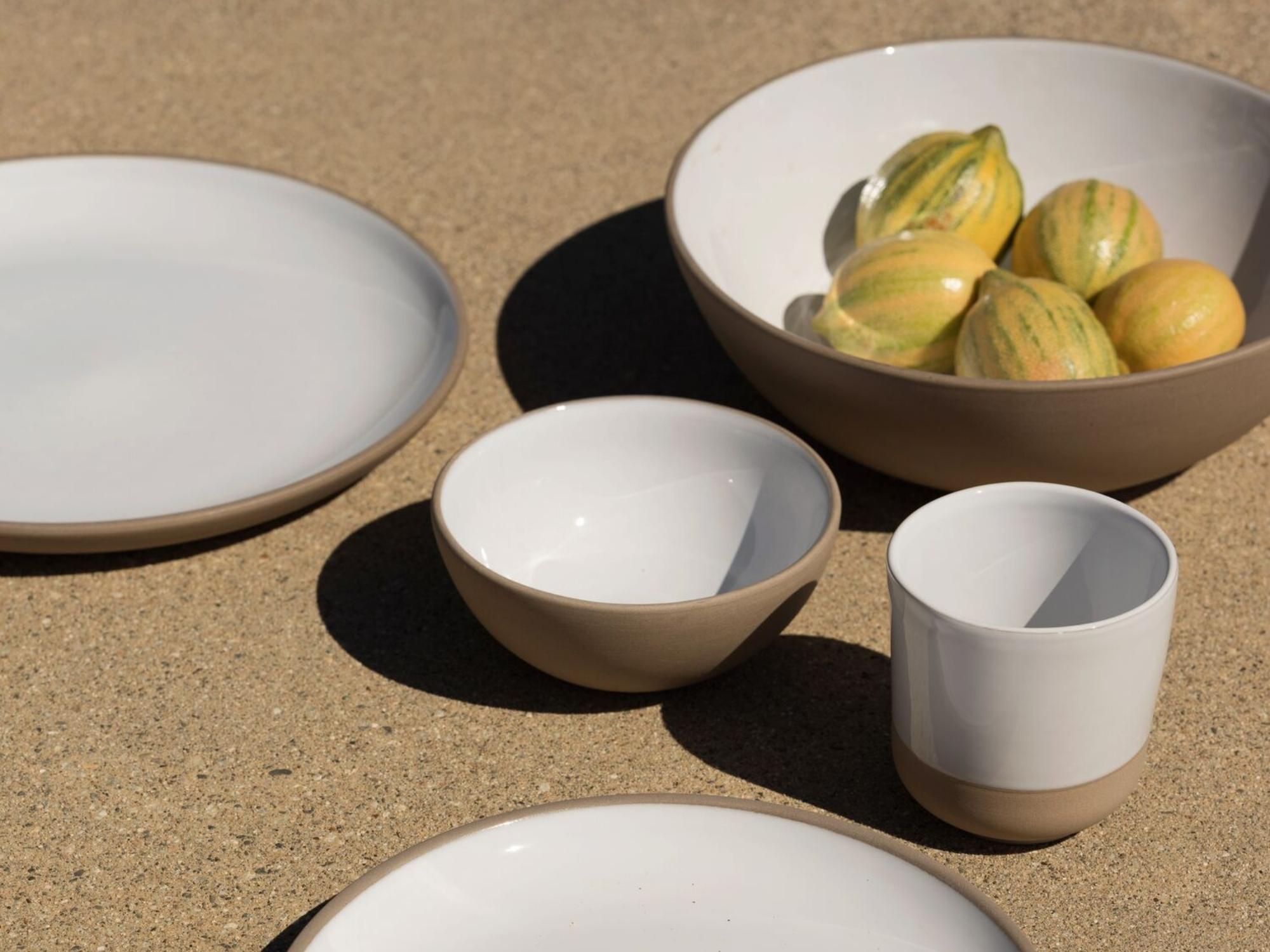 Small grey and white stoneware bowl with matching dishes around it